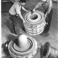 Ernest Busch and Frank Gannon molding a melting pot